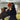woman with brown spaniel at Porth Ceiriad in a red originals 3 in 1 parka