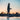Girl on a red paddle co Paddleboard paddle boarding  Abersoch North Wales at sunset on a SUP